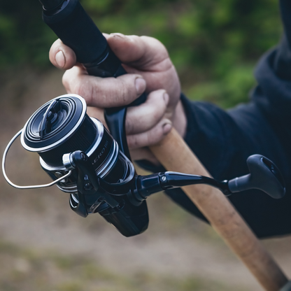 Shimano Aero BB C5000 spinning reel mounted on a rod, ready for fishing, showcasing its compact and durable design.